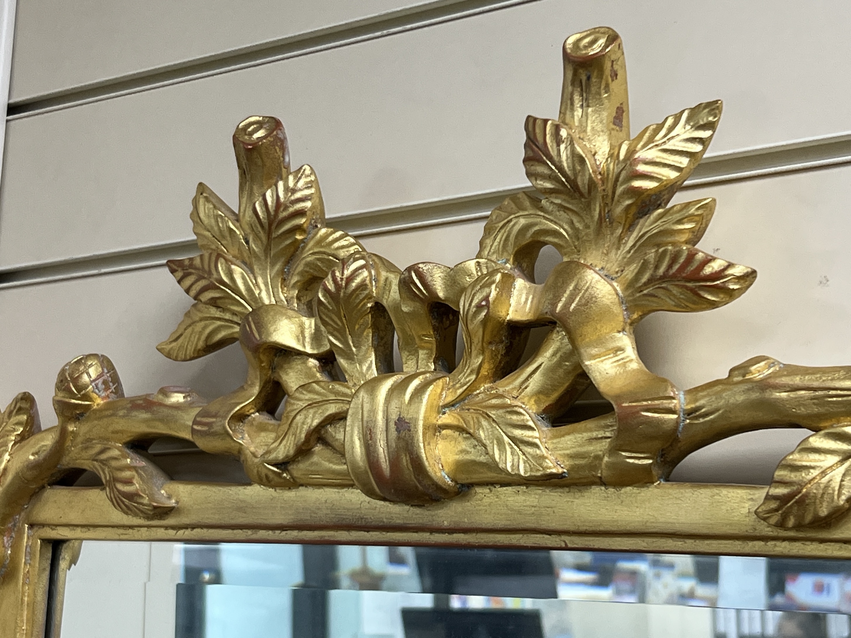 A Victorian style rectangular wall mirror with leaf and branch borders width 65cm, height 85cm.